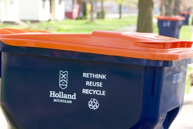 image of a blue City of Holland recycling bin with an orange lid
